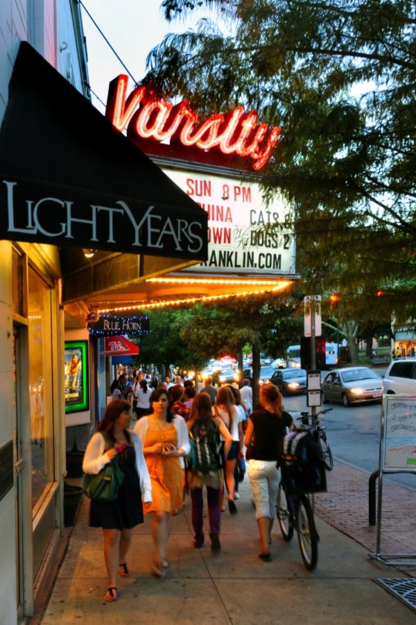 People walking by Historic Varsity Theatre