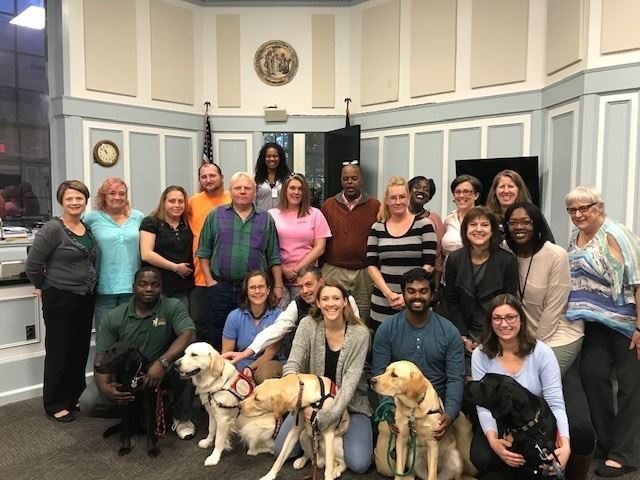 Photo of dogs and staff at courthouse