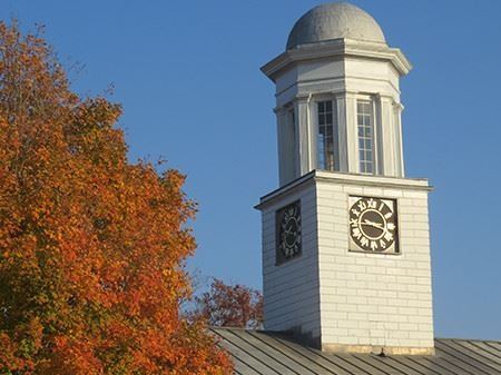 White brick building steeple against blue sky