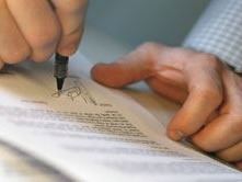 Hand singing paperwork