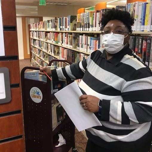 Photo of library staff working curbside service