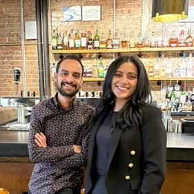 Nomad owners standing at the bar 