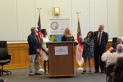 Photo of Commissioners providing gift to Medline officials